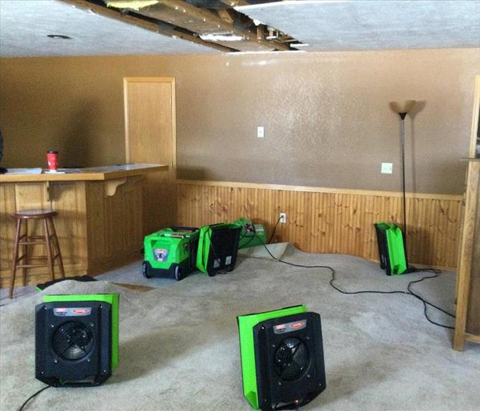 SERVPRO airmovers and drying equipment set up to dry a rug in a Joplin, MO home.
