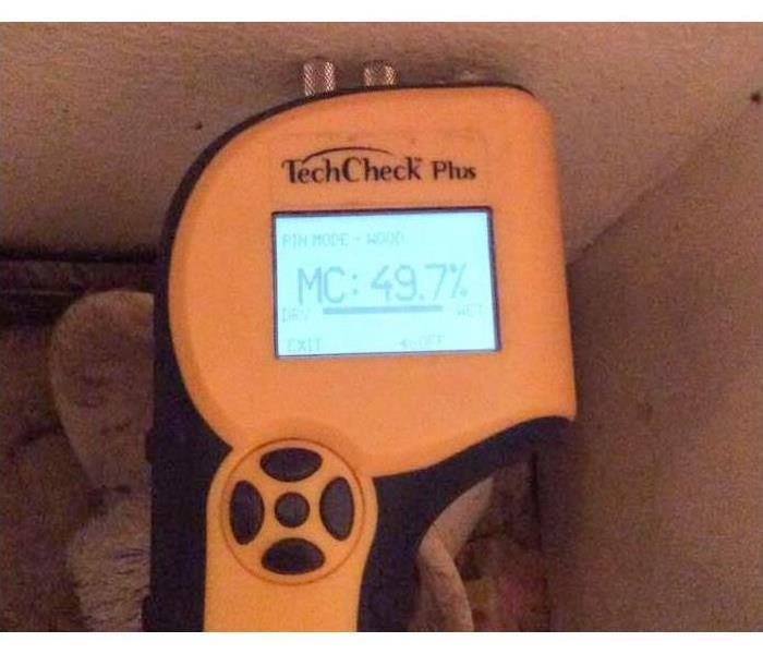 Moisture meter checking for mold in a Joplin, MO home