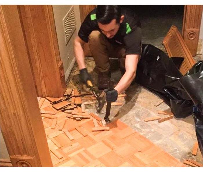 Team member removing flooring